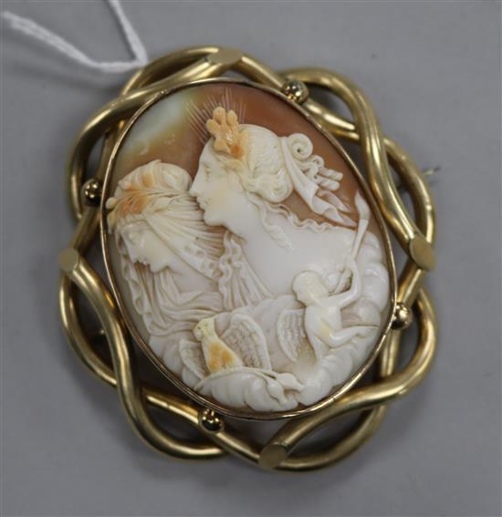 A yellow metal mounted cameo brooch carved with the figures of Night and Day, 70mm.